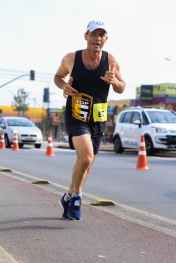 man in black tank top on roadside